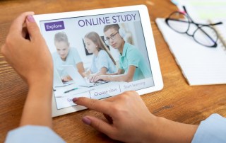 Woman pressing button on touchpad display to register on educational website