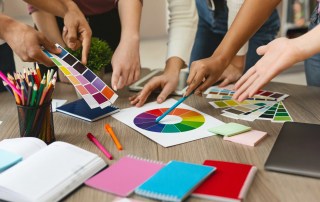 Group of young graphic designers choosing color swatch samples