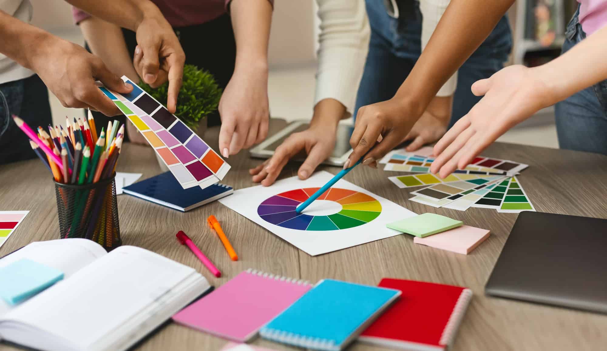 Group of young graphic designers choosing color swatch samples